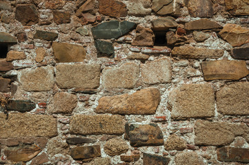 Old wall made of rough stones forming a singular background at Caceres