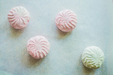 Pink and white marshmallows on parchment paper
