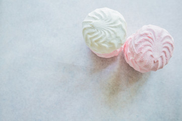 Pink and white marshmallows on parchment paper