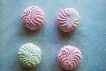 Pink and white marshmallows on parchment paper