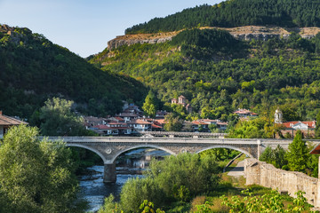 Fototapeta na wymiar View of the Vladishki bridge over Yantra river and typical terrace architecture in Veliko Tarnovo, Bulgaria