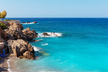 Beautiful blue lagoon with umbrellas at sandy beach, Chora Sfakion town, Crete island, Greece