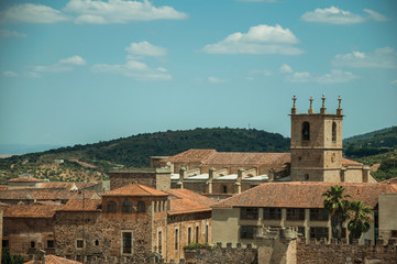 Fototapeta na wymiar Cityscape with old building roofs and church bell tower at Caceres