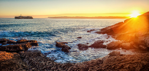 Panorama of sunrise. With a view of The Mouro Island lighthouse in Santander (Cantabria, Spain)