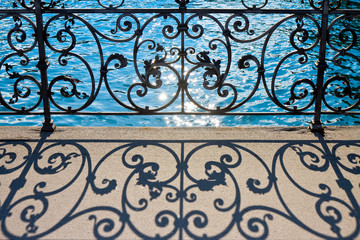 Fototapeta na wymiar Old wrought iron railing on a walkway in Lucerne (Switzerland) - image with copy space