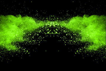 The movement of abstract dust explosion frozen green on black background. Stop the movement of powdered green on black background. Explosive powder green on black background.