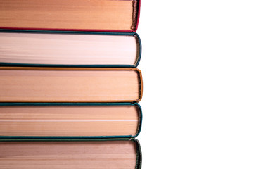 A stack of books lying on top of each other on a white background
