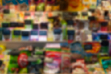 Blur supermarket background. Showcase with food (sweets, fruits, snacks)