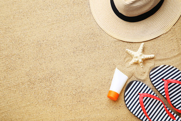 Fototapeta na wymiar Beach clothing with starfish and moisturizer cream on sand