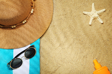 Beach clothing with towel and starfish on sand