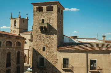 Fototapeta na wymiar Stone tower and gothic steeple church at Caceres