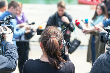 Filming news conference or media event with a video camera