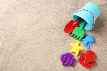 Fototapeta na wymiar Colorful plastic toys on beach sand