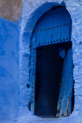 Traditional moroccan wooden door as an architectural detail in the streets of the Blue City, Chefchaouen, Morocco