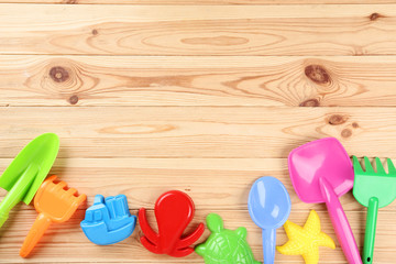 Fototapeta na wymiar Beach toys on brown wooden table