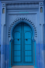 Traditional moroccan wooden door as an architectural detail in the streets of the Blue City, Chefchaouen, Morocco