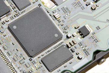 Macro photo of a green computer board with a processor, microcontroller, memory, smd components,...