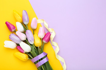 Bouquet of tulip flowers on colorful background