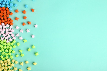 Colorful paper stars on blue background