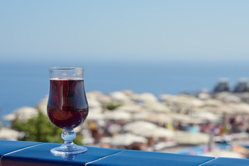 The glass of wine against the picturesque sea view illustrating the holiday and relax atmosphere.