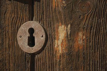 Iron keyhole in an old wooden door at Caceres