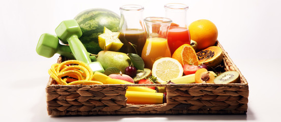 Healthy lifestyle concept. healthy fruits, smoothies and sport fitness equipment, dumbbells and jumping rope