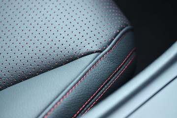 Vehicle leather seat with red perforation and stitching