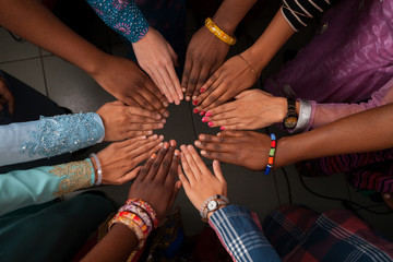 Hands of happy group of African people which stay together in circle
