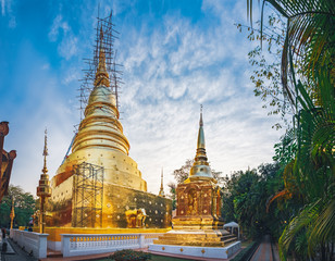 Fototapeta premium Typical Golden stupas in Wat Phra Singh in Chiang Mai, northern Thailand.