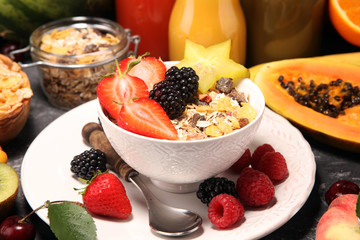Healthy breakfast. Bowl of yogurt with granola and berries, fresh fruits and smootihies