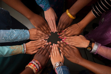 Hands of happy group of African people which stay together in circle