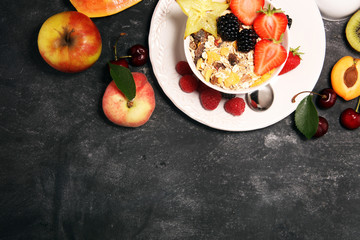 Healthy breakfast. Bowl of yogurt with granola and berries, fresh fruits and smootihies