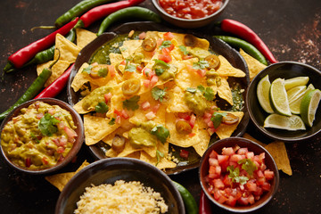 Fresh yellow corn nacho chips on ceramic plate