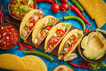 Mexican taco with chicken meat, jalapeno, fresh vegetables served with guacamole