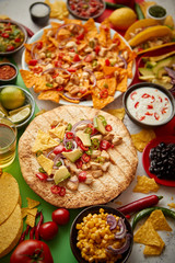 Various freshly made Mexican foods assortment. Placed on colorful table