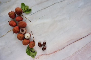 Top view of lychee isolated on marble background.