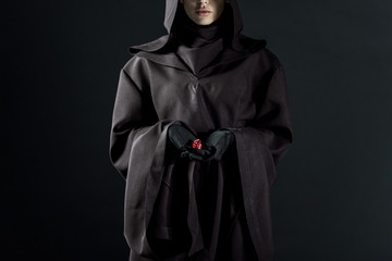cropped view of woman in death costume holding dice isolated on black