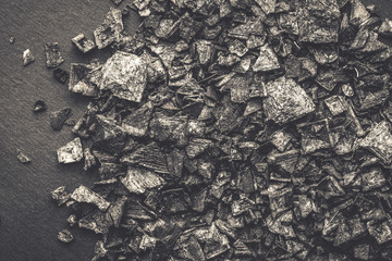 Black Salt Crystals on Dark Texture Background