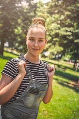 Summer woman portrait. smiling woman happy on a sunny summer or spring day outside in the park. Lifestyle tourism traveler, teen girl resting in nature, authentic summer portrait