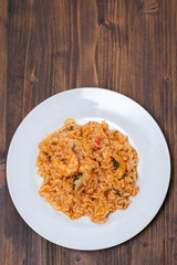 traditional portuguese dish rice with seafood in white dish