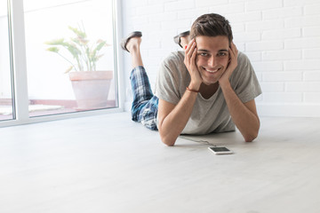 young man with mobile phone at home