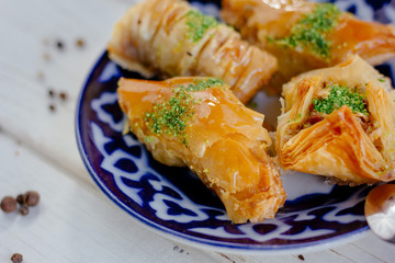 Asian dessert baklava or pahlava on a traditional oriental plate.