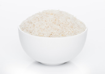 White bowl of raw organic basmati rice on white background. Healthy food.