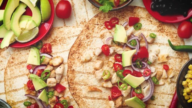 Freshly made healthy corn tortillas with grilled chicken fillet, big avocado slices