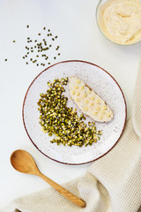 Sandwich of sprouted mung beans (mash) and cottage cheese on a white table