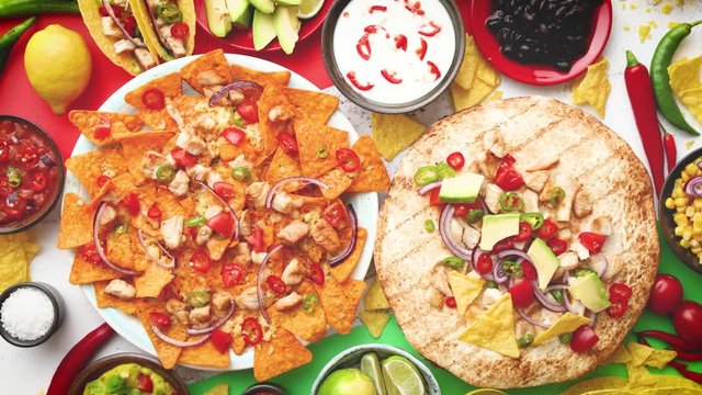 An overhead photo of an assortment of many different Mexican foods on a table