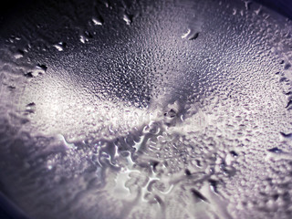 Drops of Water on Shiny Silver Metal Surface with Nested Circles.
