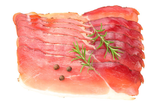 Raw smoked black forest ham with rosemary and peppercorns isolated on white background. top view