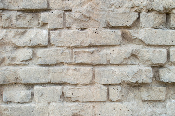 Old grey and red cracked bricks wall seamless texture