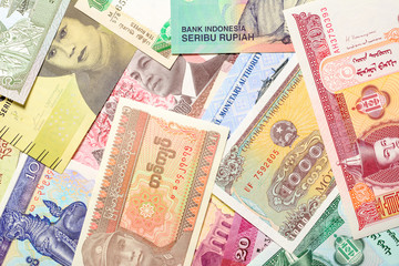 Old paper banknotes from various exotic countries. Colorful money background. Close up.